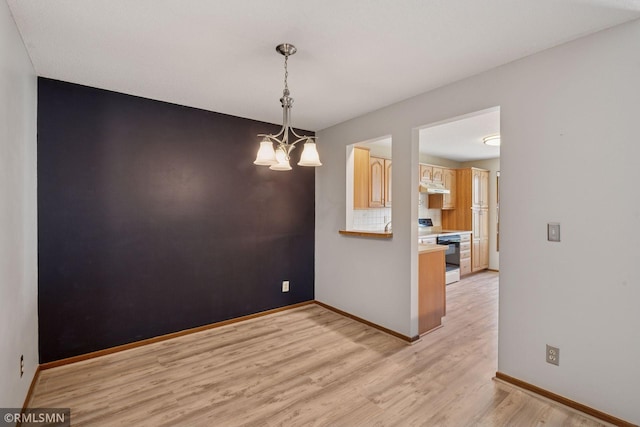 7475 110th St W, Bloomington, MN 55438 - empty room with light wood-type flooring, a chandelier, and baseboards