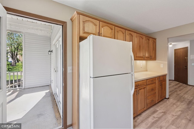 7475 110th St W, Bloomington, MN 55438 - kitchen with freestanding refrigerator, light countertops, and light wood-style floors