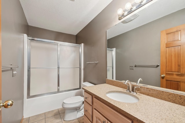 342 Soo Line Rd, Troy Twp, WI 54016 - bathroom with vanity, toilet, tile patterned floors, bath / shower combo with glass door, and a textured ceiling