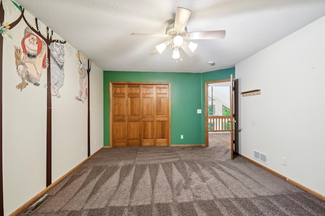 342 Soo Line Rd, Troy Twp, WI 54016 - unfurnished bedroom featuring baseboards, carpet flooring, ceiling fan, a textured ceiling, and a closet