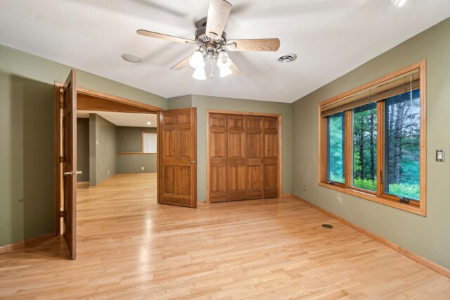 342 Soo Line Rd, Troy Twp, WI 54016 - unfurnished bedroom featuring baseboards, light wood-style flooring, a closet, and ceiling fan
