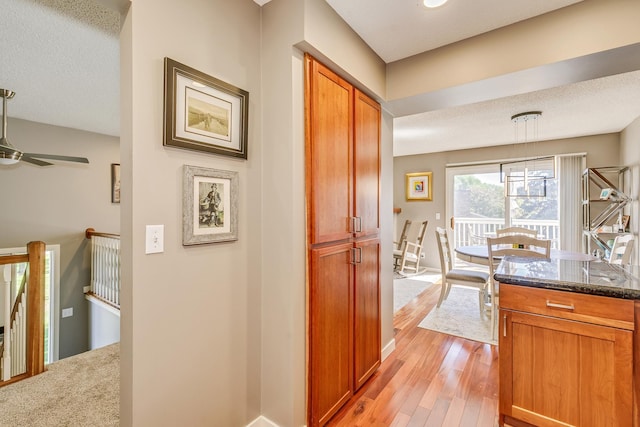 1709 140th St, Burnsville, MN 55337 - corridor featuring light wood-style floors, an upstairs landing, baseboards, and a textured ceiling
