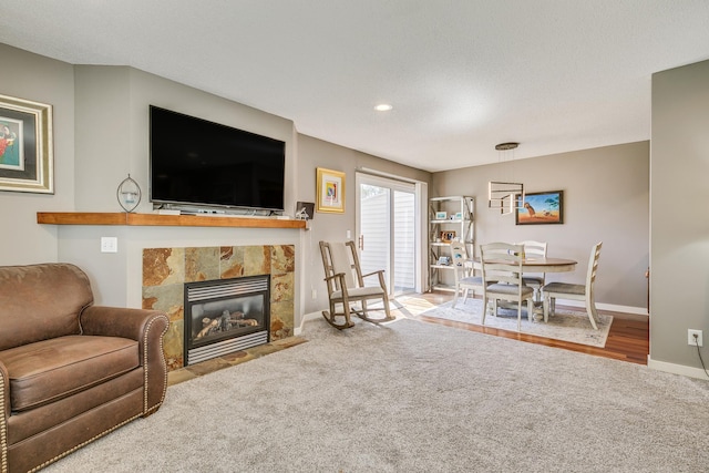 1709 140th St, Burnsville, MN 55337 - carpeted living room featuring baseboards and a tile fireplace