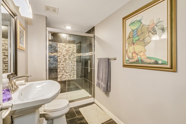 1709 140th St, Burnsville, MN 55337 - bathroom with a shower stall, toilet, a textured ceiling, tile patterned flooring, and baseboards