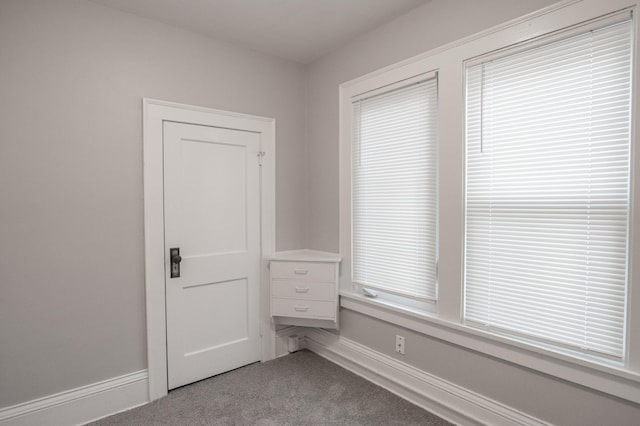 unfurnished bedroom featuring carpet flooring and baseboards