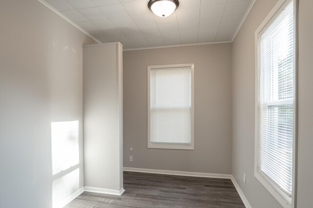 spare room featuring ornamental molding, wood finished floors, and baseboards