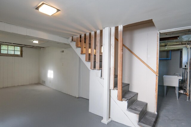 below grade area featuring stairway and a sink