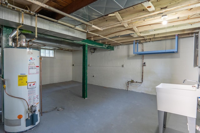 below grade area with water heater and a sink