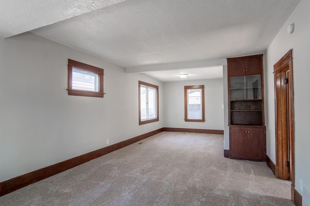 188 Wyoming St E, Saint Paul, MN 55107 - unfurnished room with light colored carpet, a textured ceiling, baseboards, healthy amount of natural light, and a smoke detector