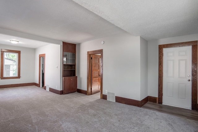 188 Wyoming St E, Saint Paul, MN 55107 - empty room with carpet flooring, baseboards, and a textured ceiling