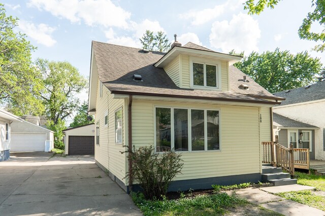 188 Wyoming St E, Saint Paul, MN 55107 - view of front facade with a detached garage and an outbuilding