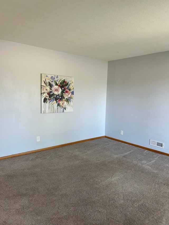 spare room with carpet floors and baseboards
