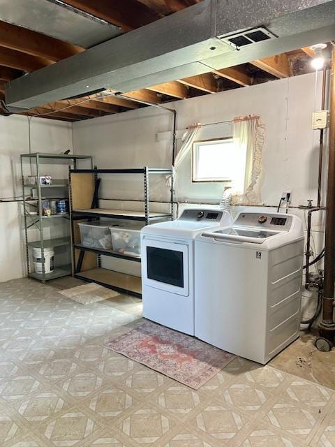 clothes washing area featuring washer and dryer and light floors
