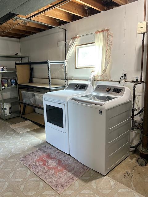 laundry area with independent washer and dryer and light flooring