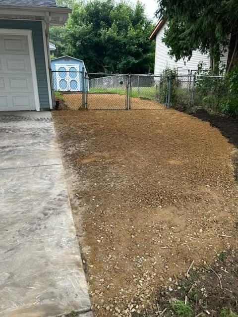 7731 80th St S, Cottage Grove, MN 55016 - view of yard with concrete driveway and a garage
