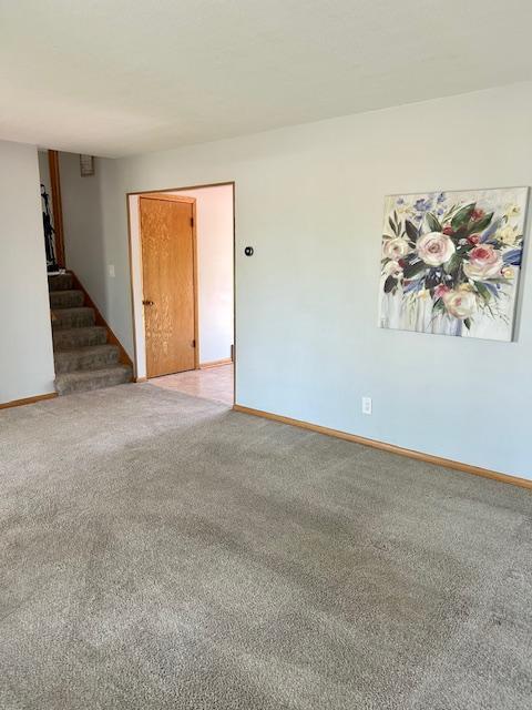 7731 80th St S, Cottage Grove, MN 55016 - empty room featuring stairs and light carpet