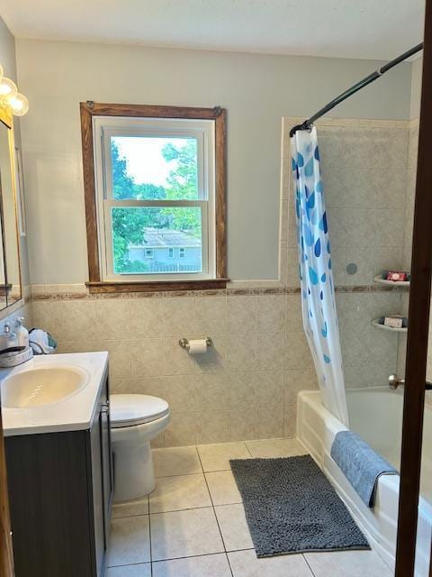 7731 80th St S, Cottage Grove, MN 55016 - full bath with vanity, tile patterned flooring, shower / bath combo with shower curtain, tile walls, and wainscoting