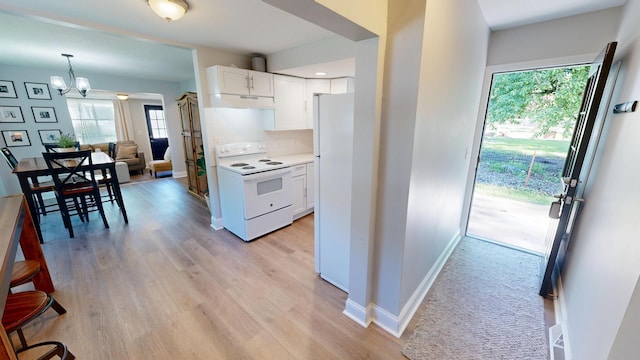 711 3rd St SE, Willmar, MN 56201 - kitchen featuring white appliances, under cabinet range hood, white cabinetry, a chandelier, and light wood-style flooring