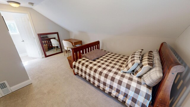 711 3rd St SE, Willmar, MN 56201 - bedroom featuring vaulted ceiling, light colored carpet, and baseboards