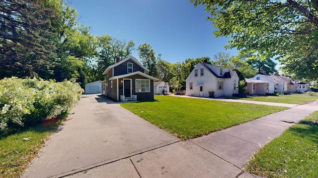 711 3rd St SE, Willmar, MN 56201 - bungalow-style home featuring an outbuilding, a front lawn, a detached garage, and a chimney