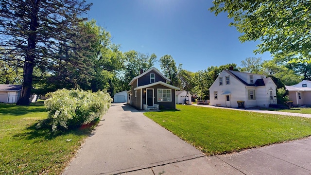 711 3rd St SE, Willmar, MN 56201 - bungalow with an outdoor structure, a front yard, and a detached garage