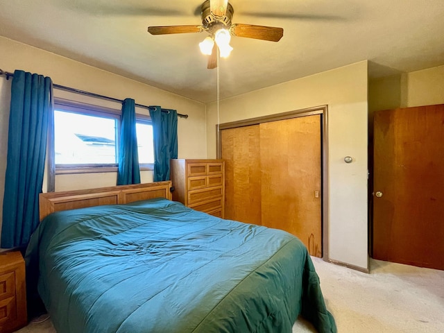 bedroom featuring a closet, light carpet, and a ceiling fan