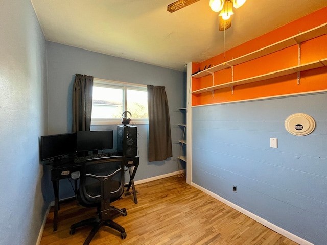 office area featuring wood finished floors, baseboards, and a ceiling fan