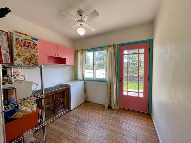 kitchen with ceiling fan, light wood-style floors, and refrigerator