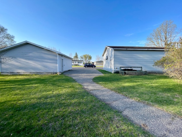 view of side of property with a lawn
