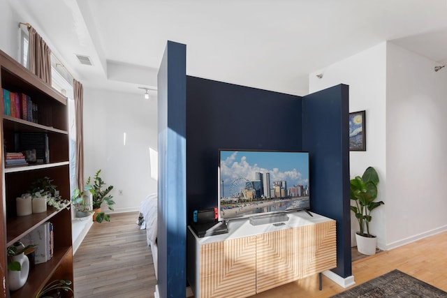 living area with wood finished floors and baseboards