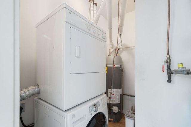 laundry room with estacked washer and dryer and water heater