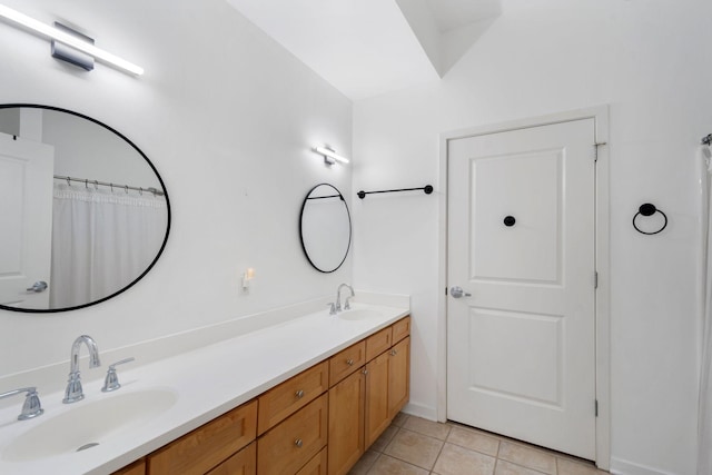 full bath with tile patterned floors and double vanity