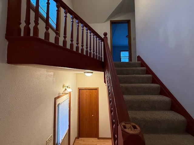 122 7th St, Montevideo, MN 56265 - staircase featuring wood finished floors and a high ceiling