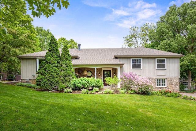 18120 Hummingbird Rd, Deephaven, MN 55391 - tri-level home with a front yard, brick siding, and a shingled roof