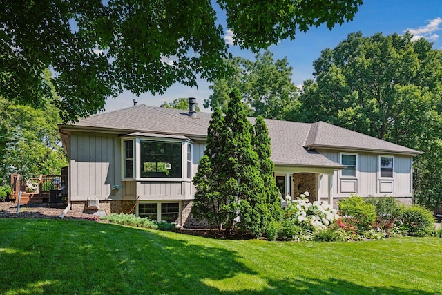 18120 Hummingbird Rd, Deephaven, MN 55391 - rear view of property with a lawn and a shingled roof