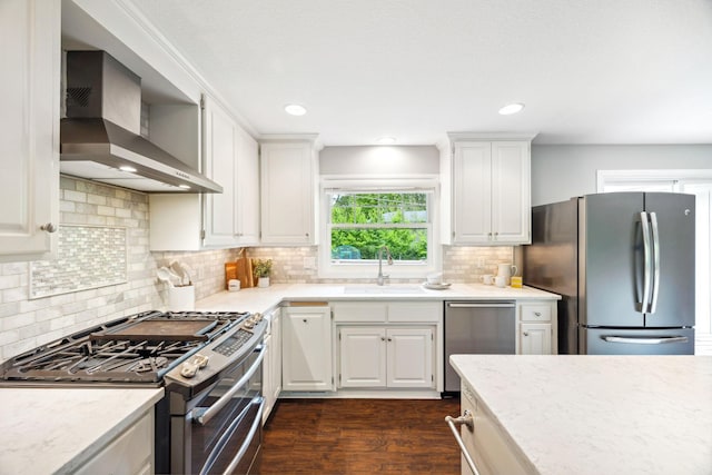 18120 Hummingbird Rd, Deephaven, MN 55391 - kitchen featuring stainless steel appliances, wall chimney range hood, a sink, dark wood-style floors, and white cabinets