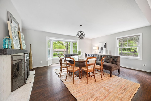 18120 Hummingbird Rd, Deephaven, MN 55391 - dining space with healthy amount of natural light, wood finished floors, and a fireplace