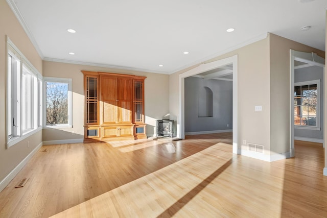5230 Rebecca Park Trl, Greenfield, MN 55357 - unfurnished living room with a wood stove, light wood-style floors, ornamental molding, baseboards, and recessed lighting