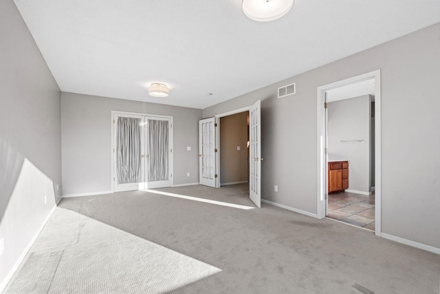 5230 Rebecca Park Trl, Greenfield, MN 55357 - unfurnished bedroom with carpet floors, baseboards, ensuite bathroom, and french doors