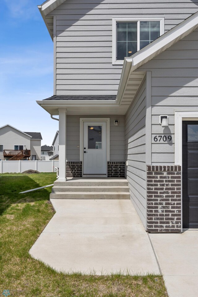view of exterior entry with brick siding