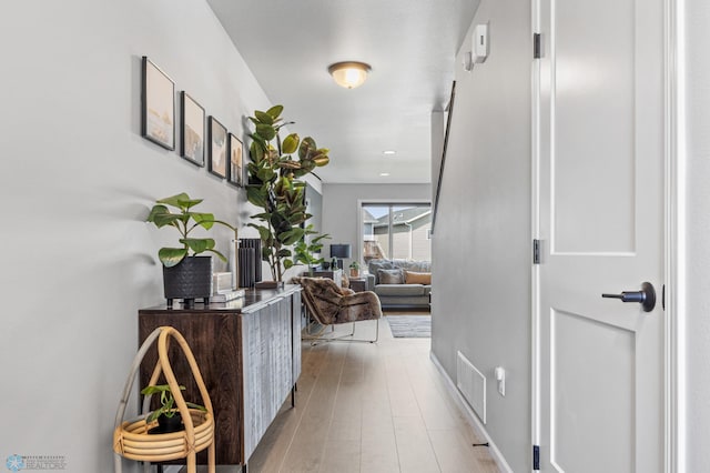 hall with wood finished floors