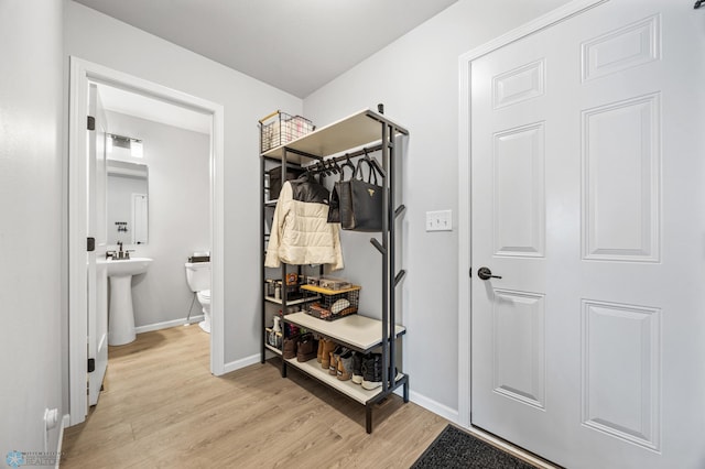 mudroom with light wood finished floors and baseboards