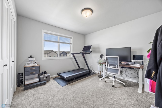 workout area featuring carpet floors and baseboards