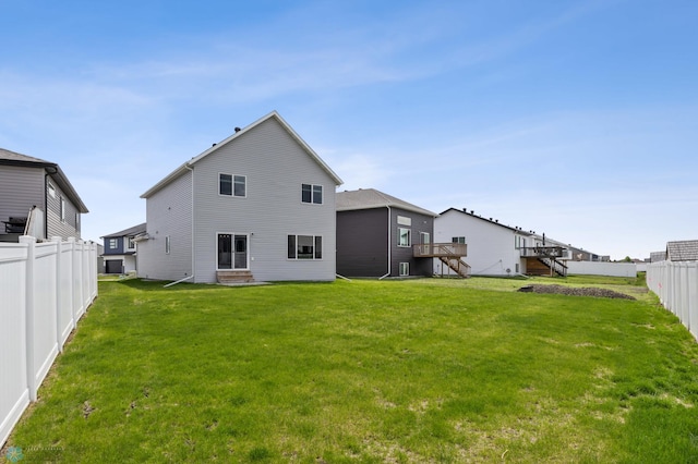 rear view of property featuring entry steps and stairway