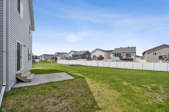view of yard featuring a residential view, a patio area, and entry steps