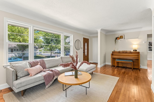 343 41st St, Minneapolis, MN 55409 - living area with light wood-type flooring, baseboards, and a textured ceiling