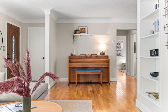343 41st St, Minneapolis, MN 55409 - living room featuring hardwood / wood-style flooring, built in shelves, and baseboards