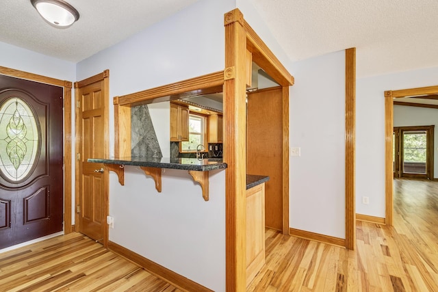 2000 191st Ave NW, Oak Grove, MN 55011 - foyer entrance featuring light wood finished floors, a textured ceiling, and baseboards