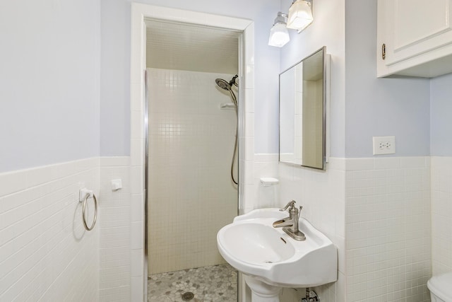 2000 191st Ave NW, Oak Grove, MN 55011 - bathroom featuring tile walls, a sink, a shower stall, wainscoting, and toilet