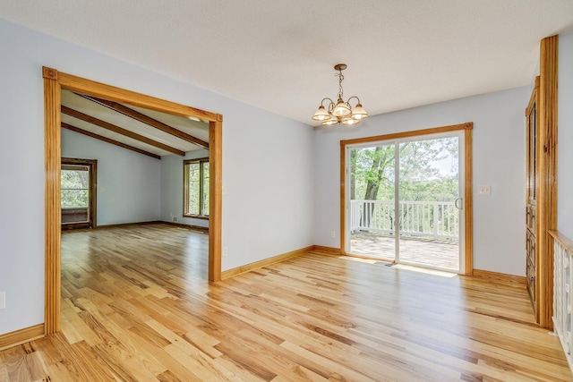 2000 191st Ave NW, Oak Grove, MN 55011 - unfurnished room featuring lofted ceiling, a chandelier, light wood-style floors, and baseboards